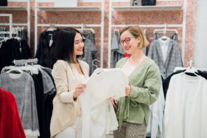 Fashion consultant showing clothes to the client